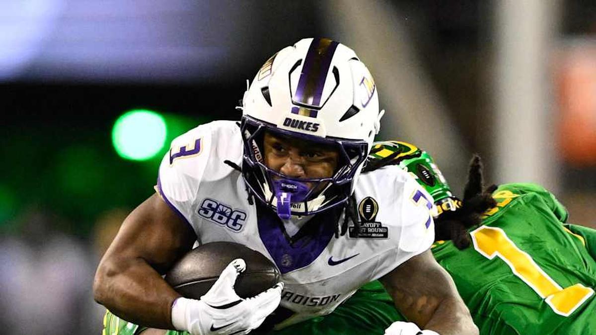  Dec 20, 2025; Eugene, OR, USA; James Madison Dukes running back Wayne Knight (3) rushes as Oregon Ducks defensive back Aaron Flowers (21) defends during the second quarter at Autzen Stadium. Mandatory Credit: Troy Wayrynen-Imagn Images | Troy Wayrynen-Imagn Images 