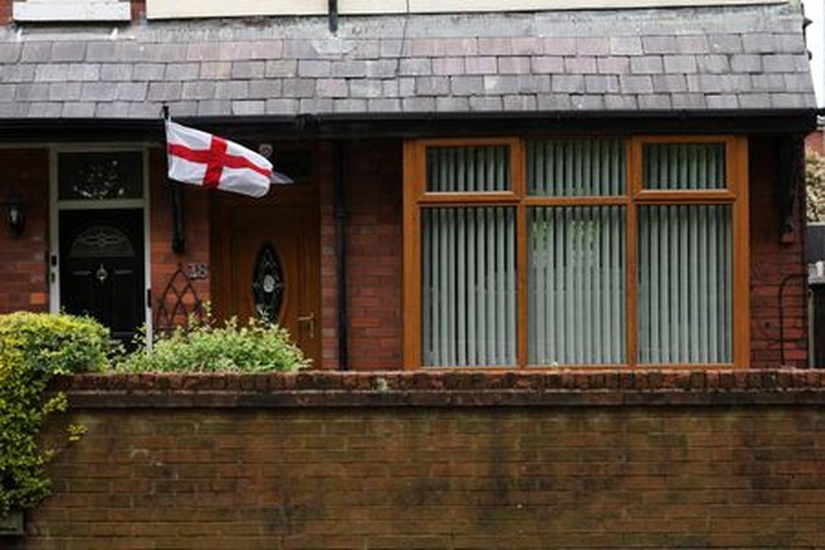 A St. George's flag is displayed at a house ahead of the Makerfield by-election, triggered by Labour MP Josh Simons, who resigned as a minister in March, in Ashton-in-Makerfield, Britain, May 20, 2026. REUTERS/Temilade Adelaja