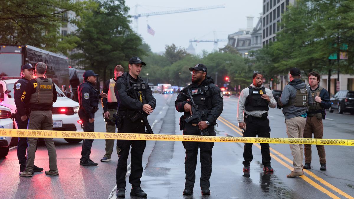 Law enforcement agents stand behind yellow tape near the White House, after gunshots were heard nearby, in Washington, D.C., U.S., May 23, 2026. REUTERS/Kylie Cooper