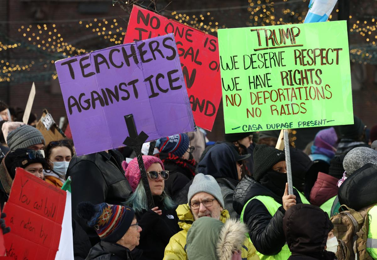Demonstrators hold signs against deportations during a march at Water Tower Park, Jan. 25, 2025, in Chicago. (John J. Kim/Chicago Tribune)