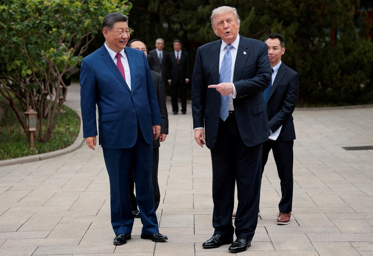 FILE PHOTO: U.S. President Donald Trump gestures towards Chinese President Xi Jinping while leaving after a visit to the Zhongnanhai Garden in Beijing, China, May 15, 2026. REUTERS/Evan Vucci/Pool/File Photo