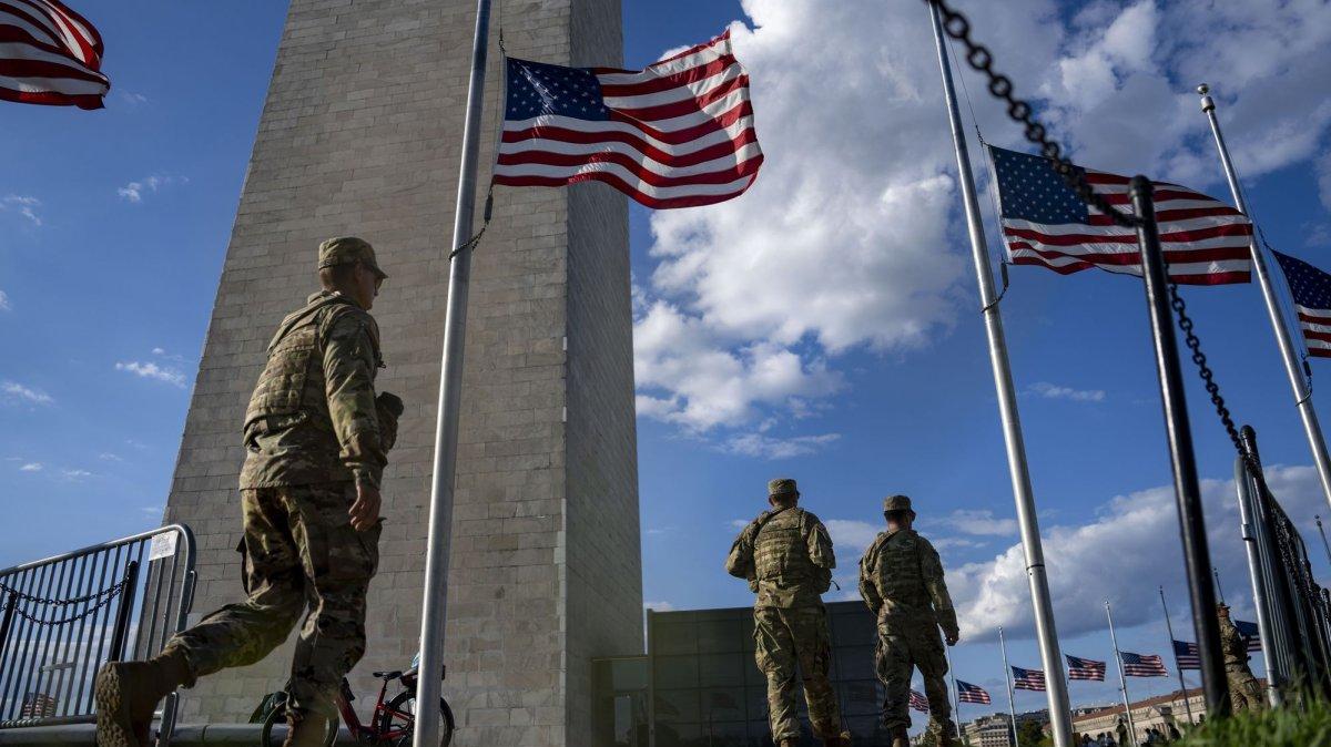 Members of the National Guard patrol the base of the Washington Monument in Washington, D.C., on Wednesday. The Trump administration deployed federal officers to the District and placed the D.C., Metropolitan Police Department under federal control to assist in crime prevention in the nation's capital.