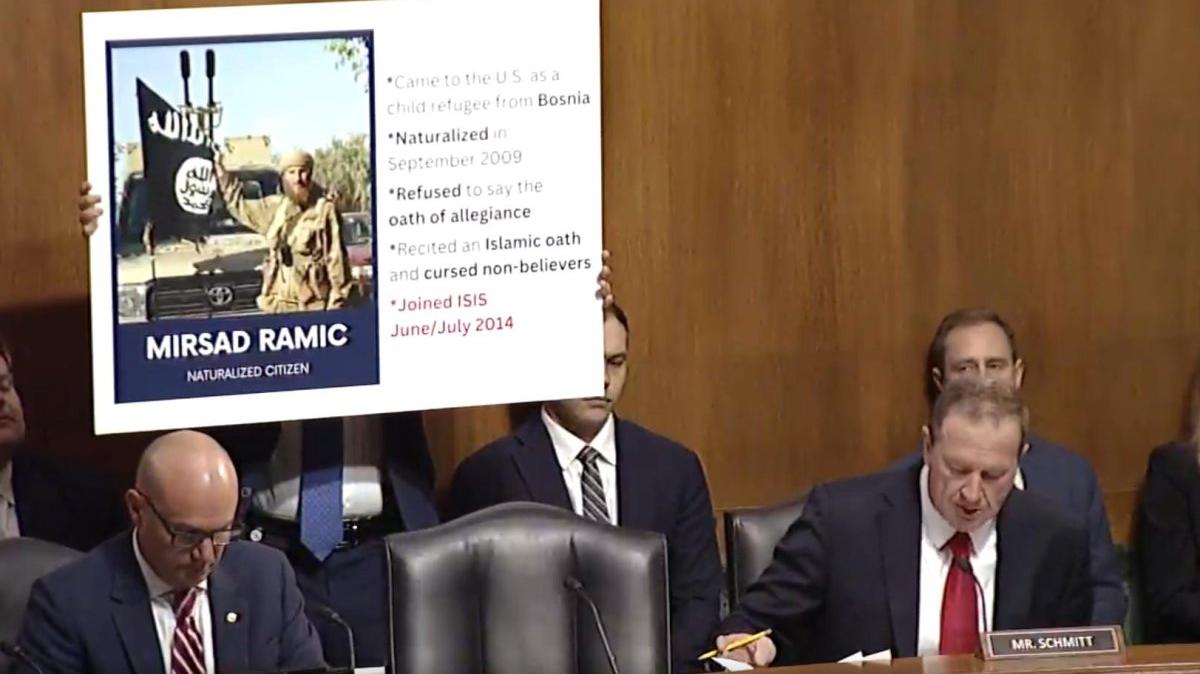 An aide to Sen. Eric Schmitt holds up a sign Wednesday depicting the radicalization of Mirsad Ramic, a naturalized U.S. citizen who was convicted in 2024 of providing material support to ISIS after traveling to Syria to join the terrorist organization. The hearing was held at the at the Dirksen Senate Office Building in Washington. Photo by Senate judiciary Committee