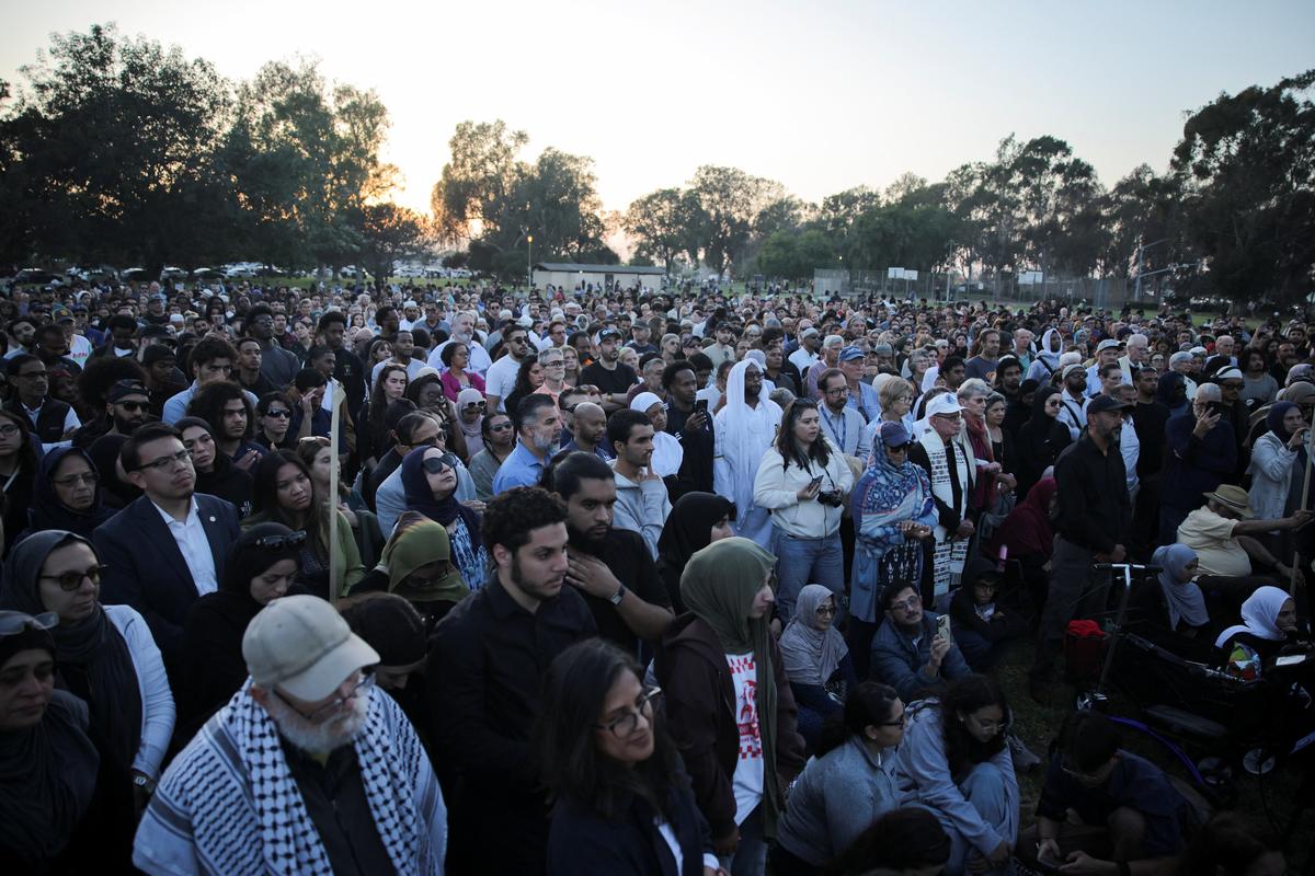 People attend a vigil in a park, the day after a fatal shooting at the Islamic Center of San Diego, in San Diego, California, U.S., May 19, 2026. REUTERS/Daniel Cole