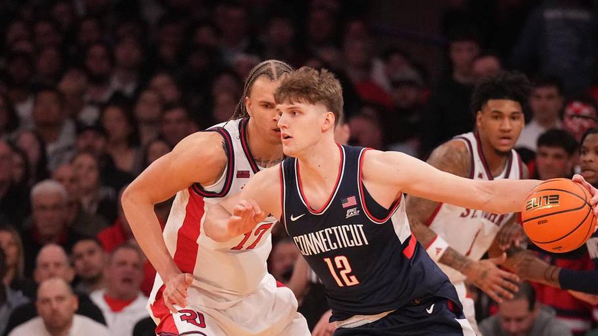  Mar 14, 2026; New York, NY, USA; Connecticut Huskies center Eric Reibe (12) works around St. John's Red Storm forward Rubén Prey (17) during the first half of the men's Big East Conference Tournament Championship at Madison Square Garden. Mandatory Credit: Robert Deutsch-Imagn Images | Robert Deutsch-Imagn Images 