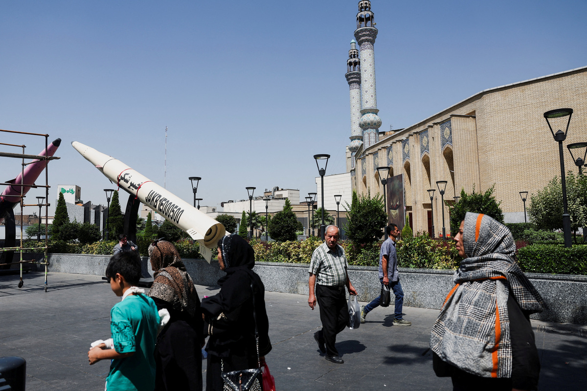 People walk next to a symbolic mock-up of an Iranian missile, on a street in Tehran, Iran, June 11, 2026. Majid Asgaripour/WANA (West Asia News Agency) via REUTERS