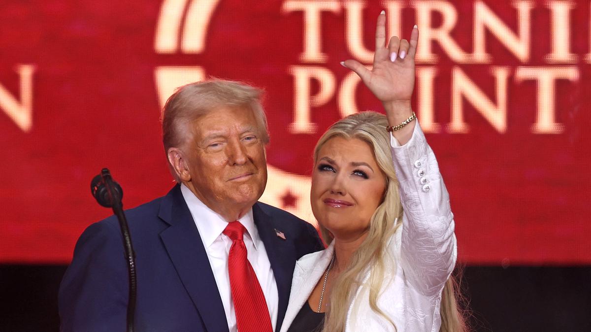 President Donald Trump and Erika Kirk, Charlie Kirk's widow, gesture during the public memorial service for the conservative activist in Glendale, Arizona.