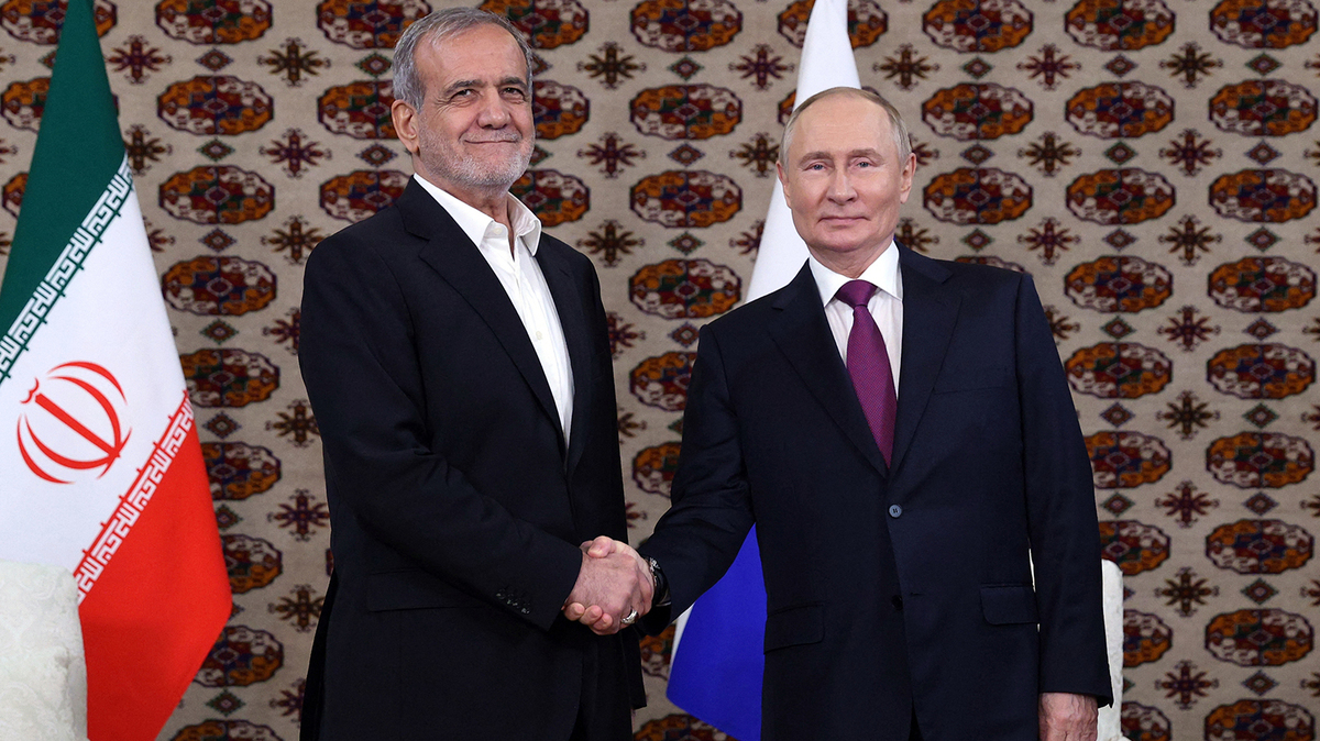 In this pool photograph distributed by the Russian state agency Sputnik, Russia's President Vladimir Putin meets with Iran's President Masoud Pezeshkian on the sidelines of an international forum "Interrelation of times and civilizations - basis of peace and development" dedicated to the 300th anniversary of poet Magtymguly Fragi's birthday in Ashgabat on Oct. 11, 2024. (Alexander Shcherbak/Pool/AFP via Getty Images/TNS)