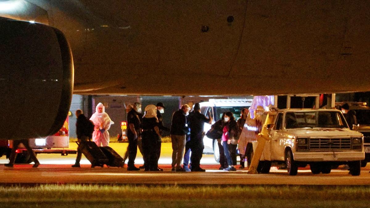 Personnel from various agencies assist in the disembarkation of passengers evacuated from the cruise ship MV Hondius, which was affected by a hantavirus outbreak, and arrived on a chartered aircraft at Eppley Airfield in Omaha, Nebraska, U.S. May 11, 2026.  REUTERS/Hayden Smith