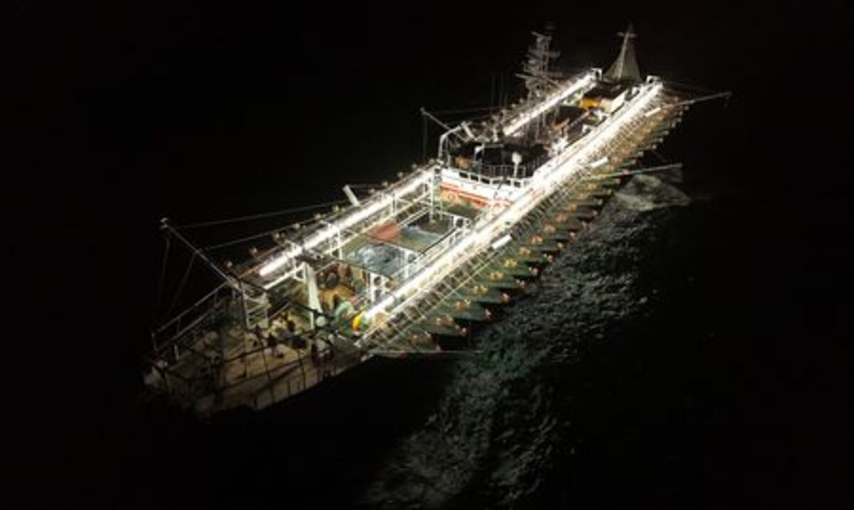 A drone view shows crew members aboard a squid jigger vessel operating outside Argentina's exclusive economic zone, where foreign fishing vessels, mostly Chinese, operate just beyond the boundary, in the South Atlantic Ocean off the coast of Argentina, January 18, 2026. REUTERS/Agustin Marcarian