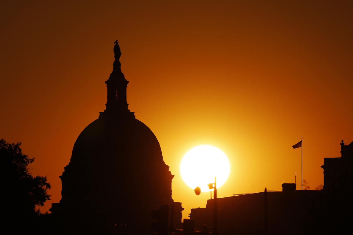  The sun sets behind the U.S. Capitol Building during a heat wave on June 7, 2026, in Washington. As many as 30 states are at risk of extreme heat between June 30 and July 6. 
