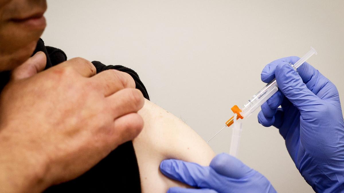 John Garcia receives a COVID-19 vaccine from Pharmacy Manager Suzette Crumley at Vons, Tuesday, Aug. 27, 2024, in San Diego, California.