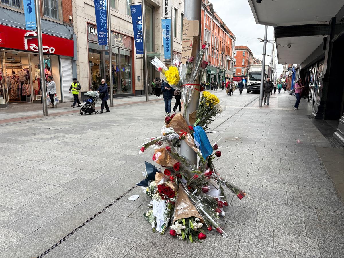 Flowers are laid outside a department store on Henry Street where a Congolese-born man, Yves Sakila, was restrained by security guards last week and later pronounced dead in hospital, in Dublin, Ireland, May 20, 2026. REUTERS/Conor Humphries