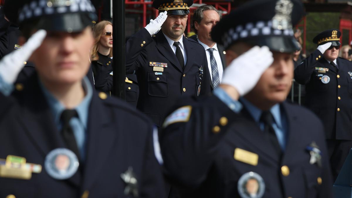 Chicago police officers salute at the start of funeral services for Officer John Bartholomew, at St. Andrew Greek Orthodox Church in Chicago, May 8, 2026. (Antonio Perez/Chicago Tribune/TNS)