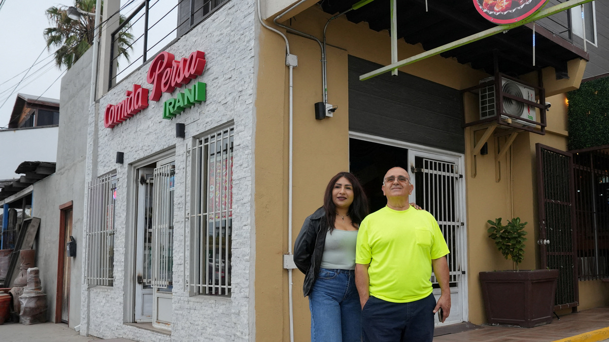 Iranian Saied Assadi, owner of the Comida Persa Iran restaurant, and his Mexican partner Claudia Leonardo pose outside the venue in Rosarito, on the outskirts of Tijuana, where a small Iranian community reflects broader political divisions within the diaspora ahead of the team’s World Cup campaign, in Rosarito, Mexico, June 10, 2026. REUTERS/Aimee Melo
