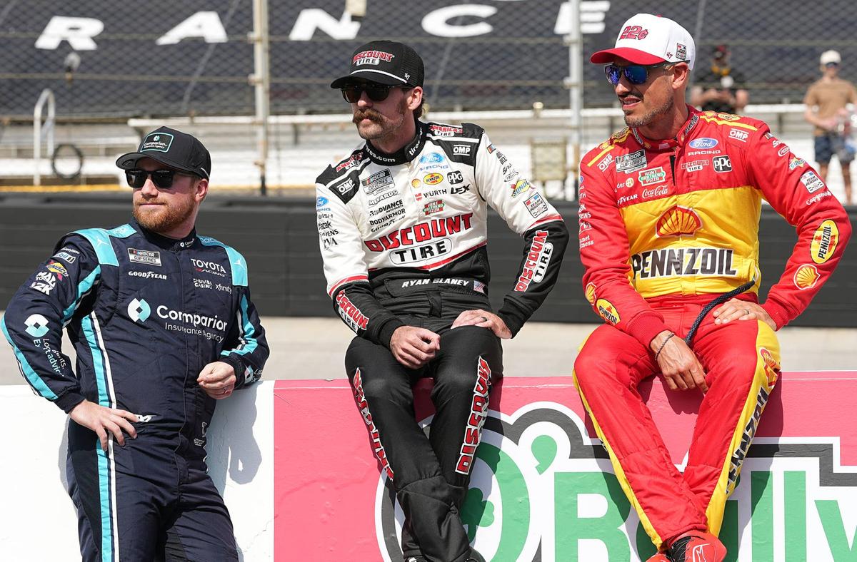  Tyler Reddick speaks with Team Penske drivers, Ryan Blaney and Joey Logano, at Bristol. (Photo by Matt Kelley/Getty Images)