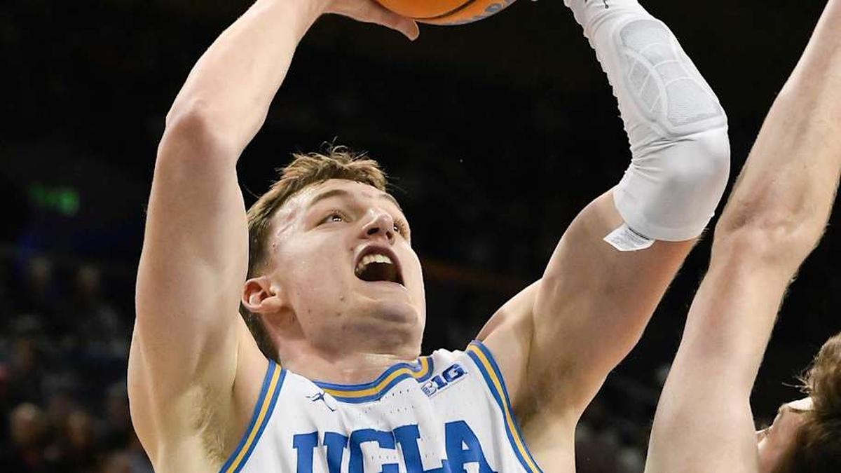  Mar 3, 2026; Los Angeles, California, USA; UCLA Bruins forward Tyler Bilodeau (34) scores over Nebraska Cornhuskers forward Pryce Sandfort (21) during the first half at Pauley Pavilion presented by Wescom Financial. Mandatory Credit: Robert Hanashiro-Imagn Images | Robert Hanashiro-Imagn Images 