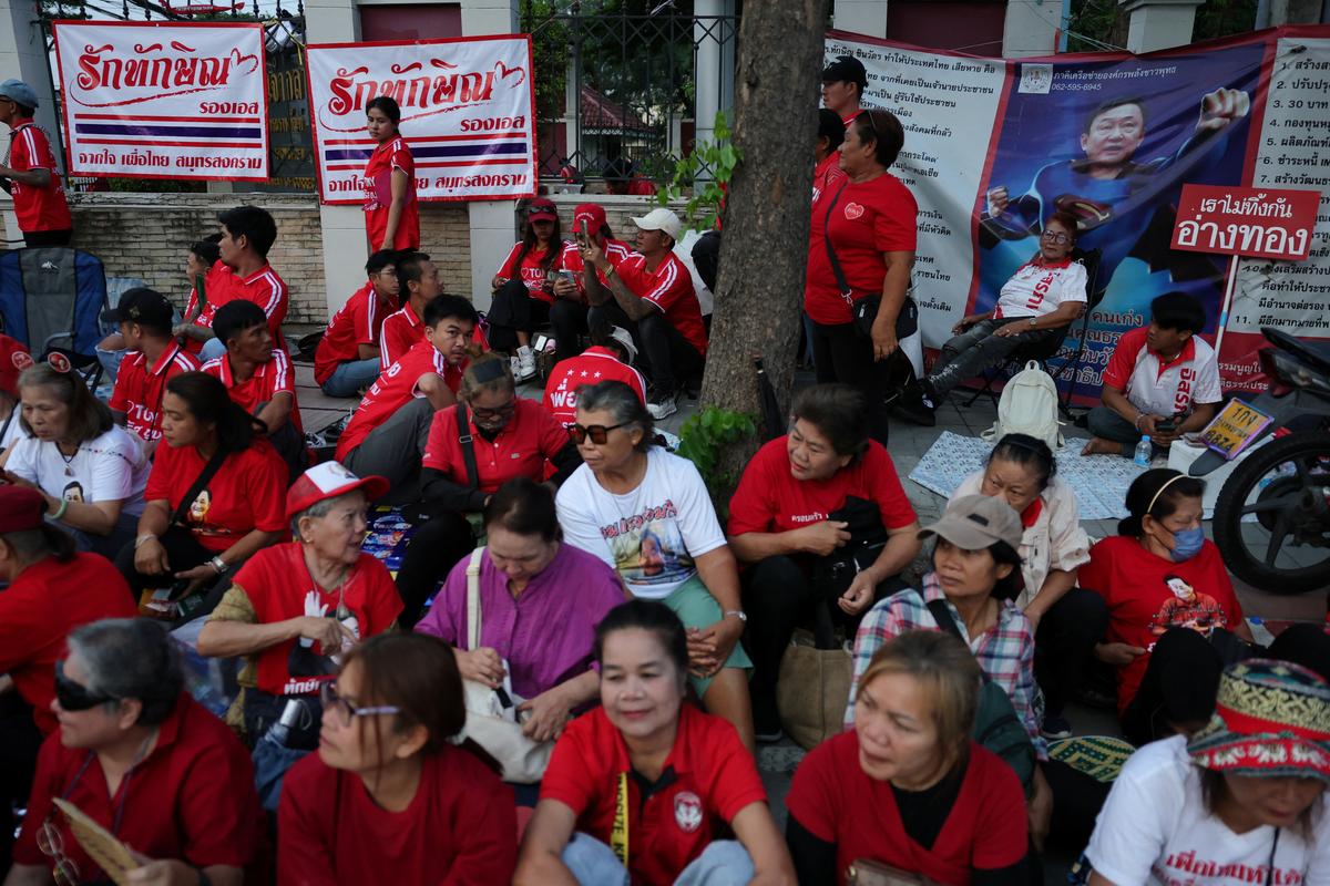 Supporters of former Thai Prime Minister Thaksin Shinawatra wait for his release on parole after serving eight months of his one-year sentence at Klong Prem Central Prison, in Bangkok, Thailand, May 11, 2026. REUTERS/Athit Perawongmetha