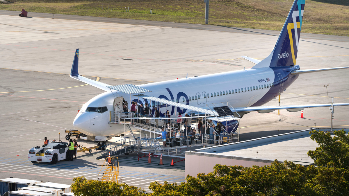 Passengers board an Avelo Airline jet at Palm Beach International Airport on March 11, 2026, in West Palm Beach, Florida.