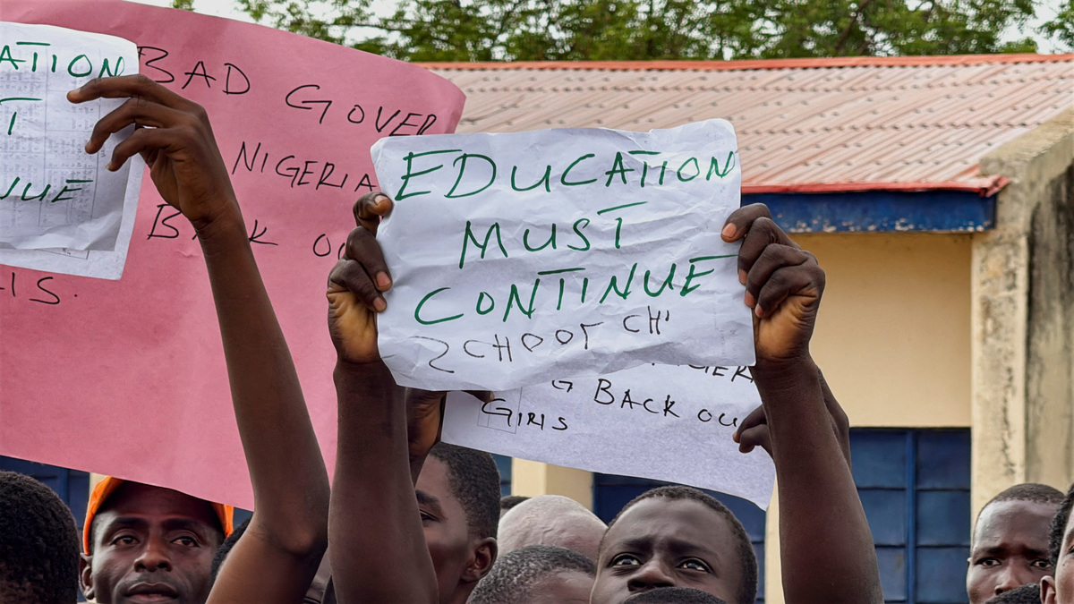 Parents display signs as they protest over their abducted children a day after gunmen stormed Government Day Secondary School and abducted students during exams, in Lassa, Borno State, Nigeria, June 30, 2026. Picture taken with a mobile phone. REUTERS/Umaru Kirawa