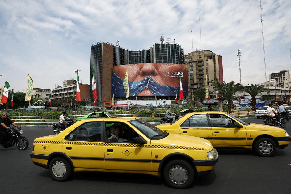 People drive past an anti-U.S. billboard depicting U.S. President Donald Trump and the Strait of Hormuz, in Tehran, Iran, May 2, 2026. Majid Asgaripour/WANA (West Asia News Agency) via REUTERS ATTENTION EDITORS - THIS PICTURE WAS PROVIDED BY A THIRD PARTY