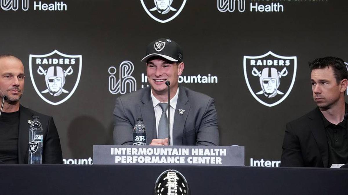  Apr 24, 2026; Henderson, NV, USA; Las Vegas Raiders quarterback Fernando Mendoza (center) speaks at introductory press conference at Intermountain Health Performance Center flanked by general manager John Spytek (left) and head coach Klint Kubiak after being selected as the No. 1 pick in the 2026 NFL Draft. Mandatory Credit: Kirby Lee-Imagn Images | Kirby Lee-Imagn Images 