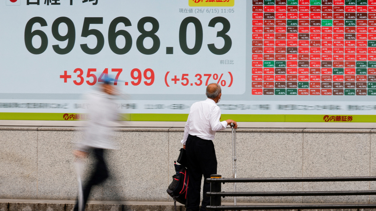 A man looks at a stock quotation board showing the Nikkei share average outside a brokerage in Tokyo, Japan, June 15, 2026. Picture taken with slow shutter speed. REUTERS/Kim Kyung-Hoon