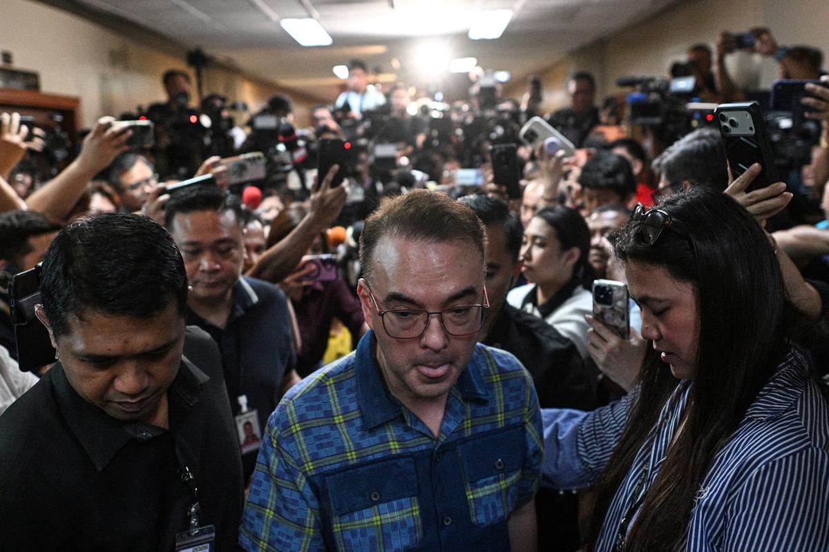 Philippines Senate President Alan Peter Cayetano walks away from reporters after postponing a press conference near the site where gunshots were heard at the Philippine Senate on Wednesday, in Pasay City, Metro Manila, Philippines, May 14, 2026. REUTERS/Noel Celios
