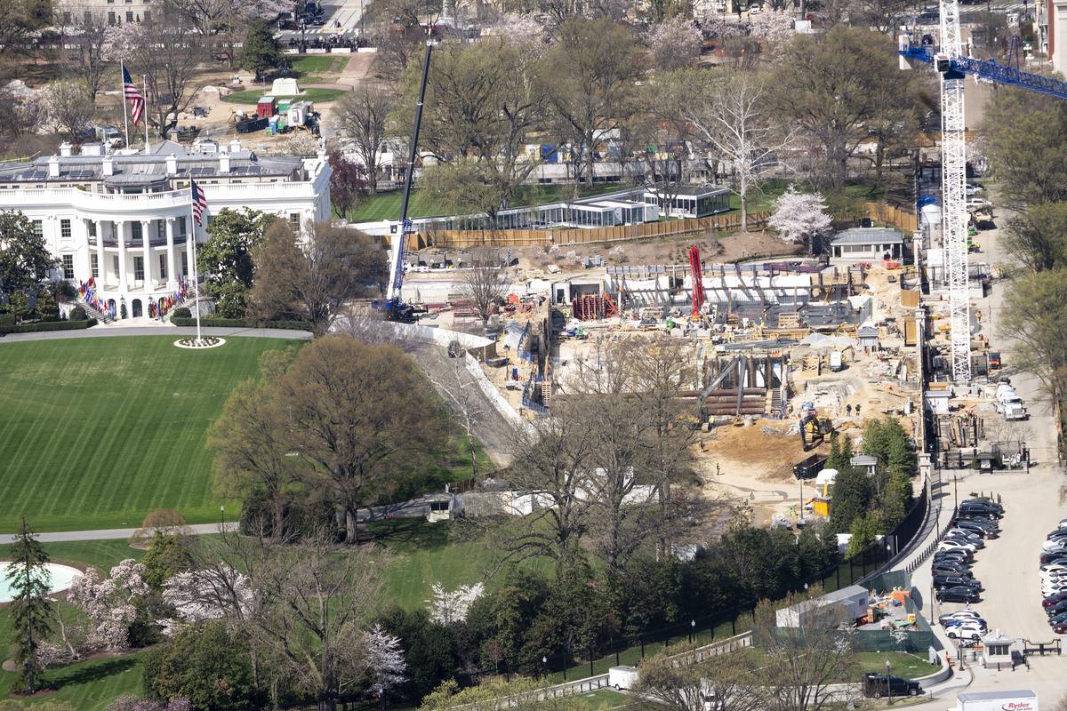 FILE -- The construction for the new White House ballroom on the East Wing of The White House, in Washington, on Wednesday, March, 25, 2026. President Donald Trump's vision for his National Garden of American Heroes is growing larger and most likely more expensive than his initial estimates, with the latest plans calling for reflecting pools, dining facilities and an amphitheater alongside 250 life-size statues of notable Americans. (Doug Mills/The New York Times).