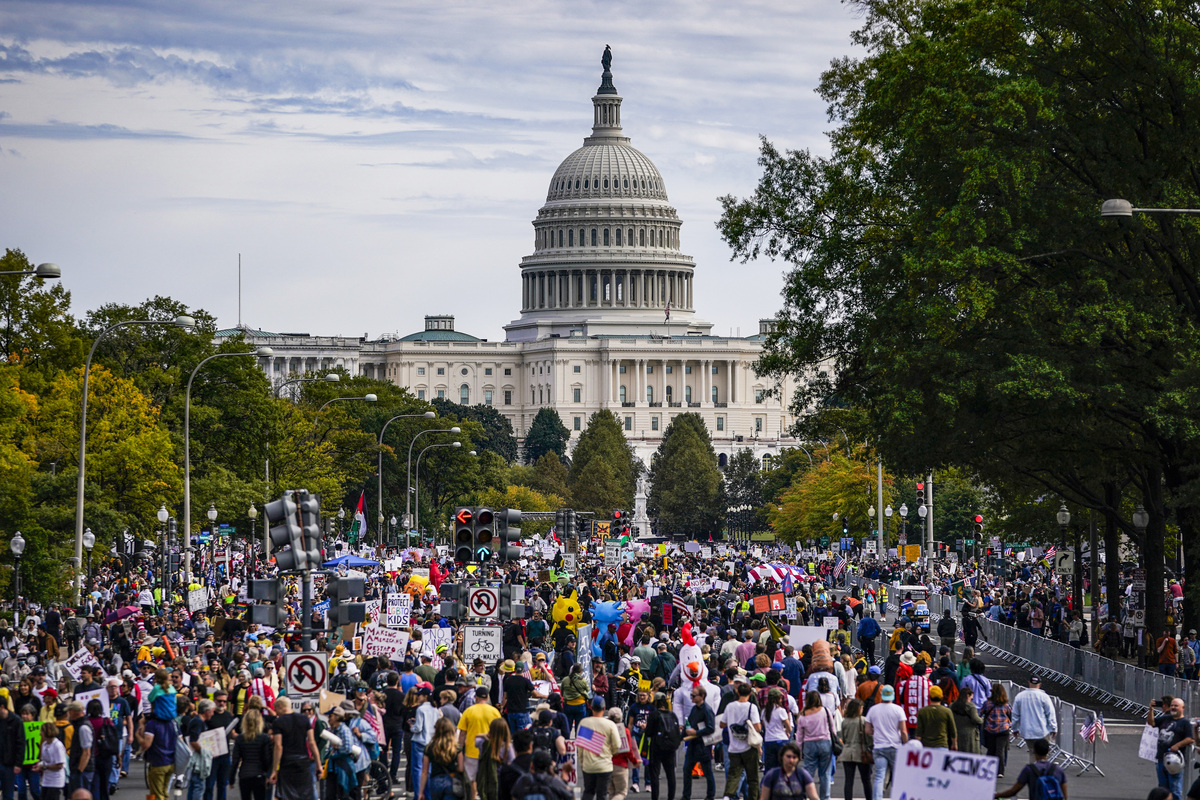  Protesters march along Pennsylvania Avenue during a No Kings protest on October 18, 2025. 