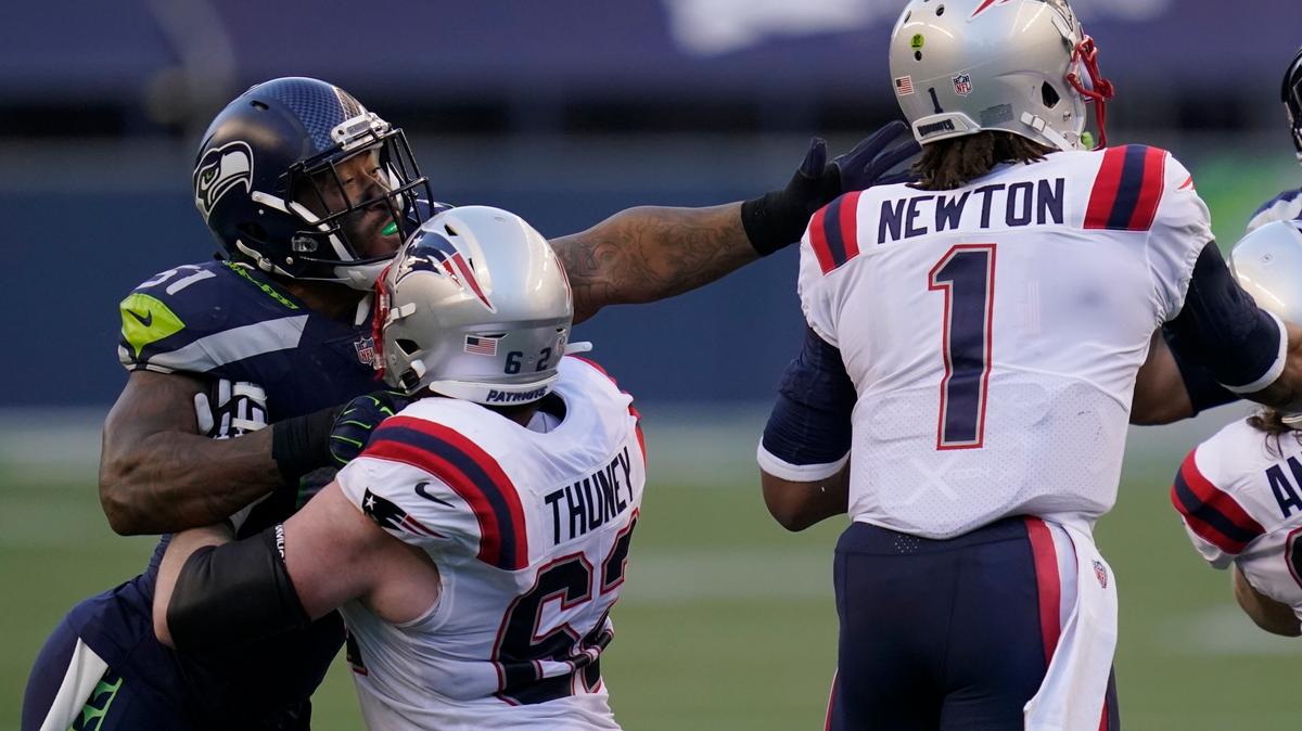 FILE - In this Sunday, Sept. 20, 2020, file photo, Seattle Seahawks linebacker Bruce Irvin, letft, is blocked by New England Patriots offensive guard Joe Thuney as he pressures quarterback Cam Newton (1) during the first half of an NFL football game, in Seattle. A big part of the success the Patriots have enjoyed on offense this season has to do with the discipline of its offensive line. (AP Photo/Elaine Thompson, File)