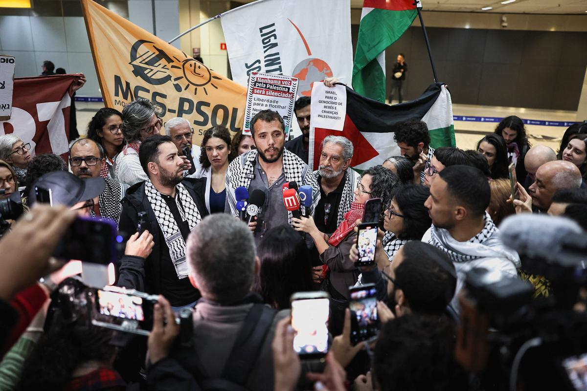 Brazilian activist Thiago Avila, who was detained aboard the Gaza-bound Global Sumud Flotilla, which was intercepted by Israeli forces, speaks to the media upon arrival at Sao Paulo/Guarulhos International Airport after being deported, in Guarulhos, Brazil, May 11, 2026. REUTERS/Amanda Perobelli