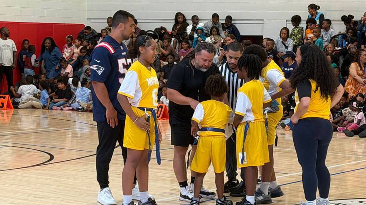  New England Patriots linebacker Christian Elliss stopped by the Mattahunt School to help coach in their flag football game. | Ethan Hurwitz / Patriots On SI 