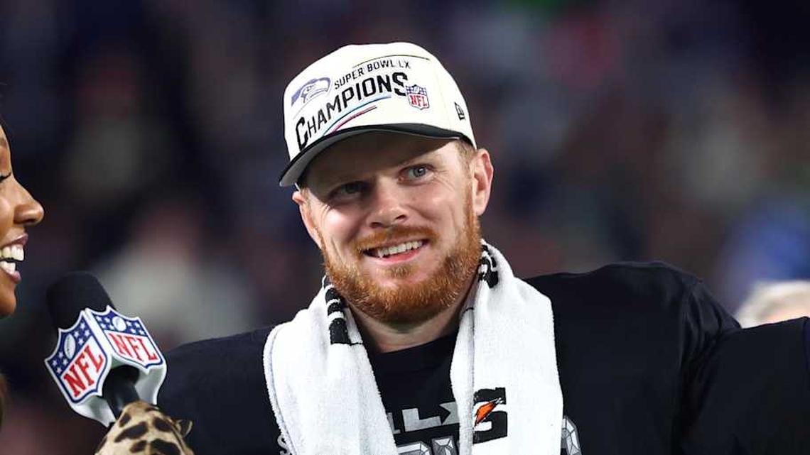  Feb 8, 2026; Santa Clara, CA, USA; Seattle Seahawks quarterback Sam Darnold (14) celebrates with the Vince Lombardi trophy on the podium after defeating the New England Patriots in Super Bowl LX at Levi's Stadium. Mandatory Credit: Mark J. Rebilas-Imagn Images | Mark J. Rebilas-Imagn Images 