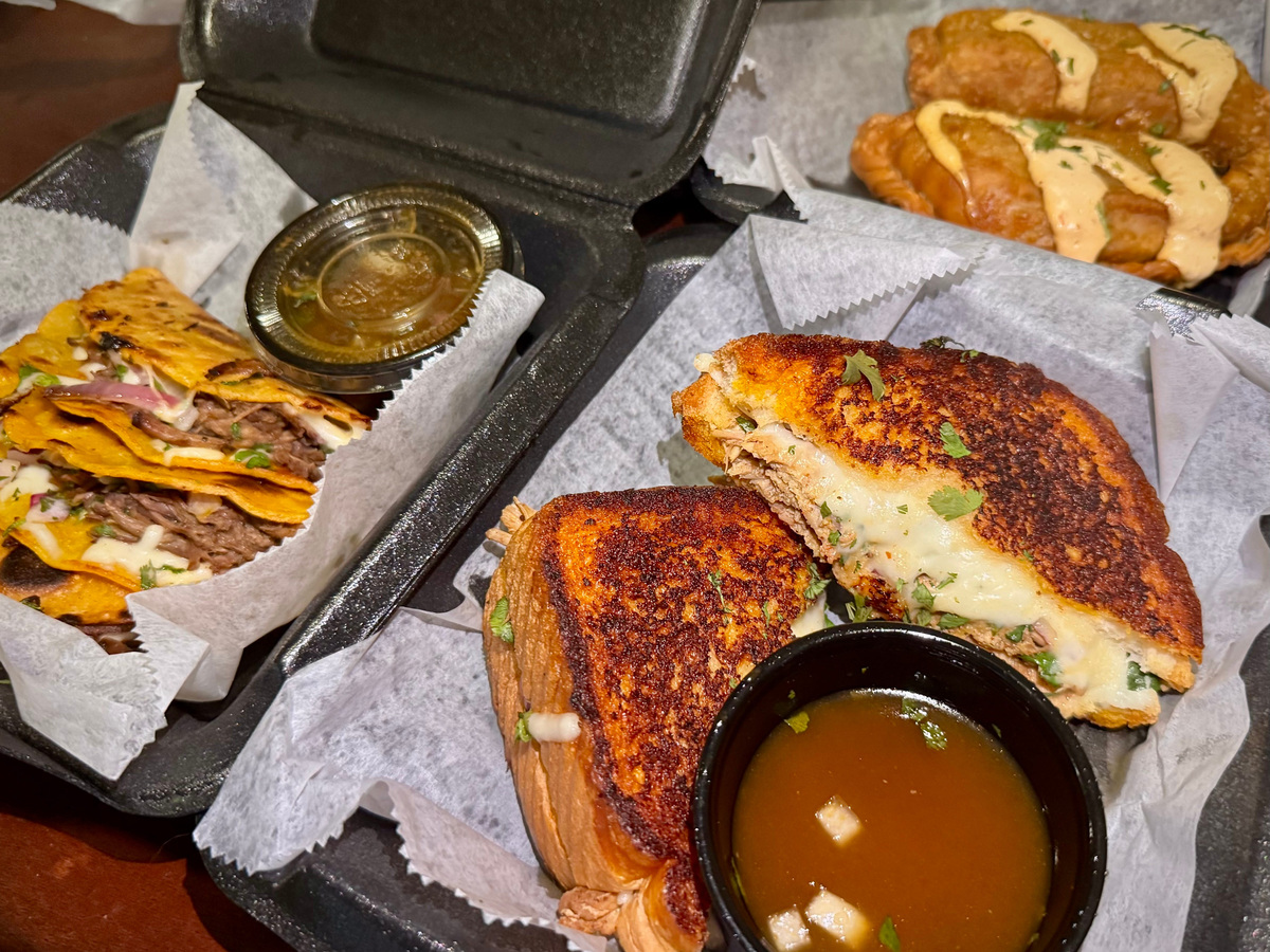 Birria tacos (left), birria grilled cheese and Spanish chicken empanadas from Double Dippin food trailer.