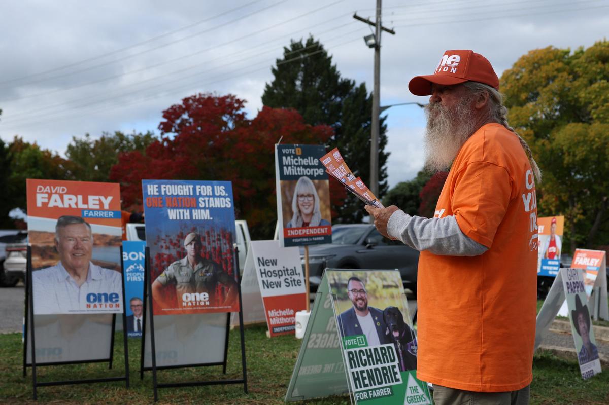 A One Nation campaign volunteer stands outside a pre-polling centre ahead of the Farrer by-election in Albury, Australia, May 6, 2026. REUTERS/Hollie Adams
