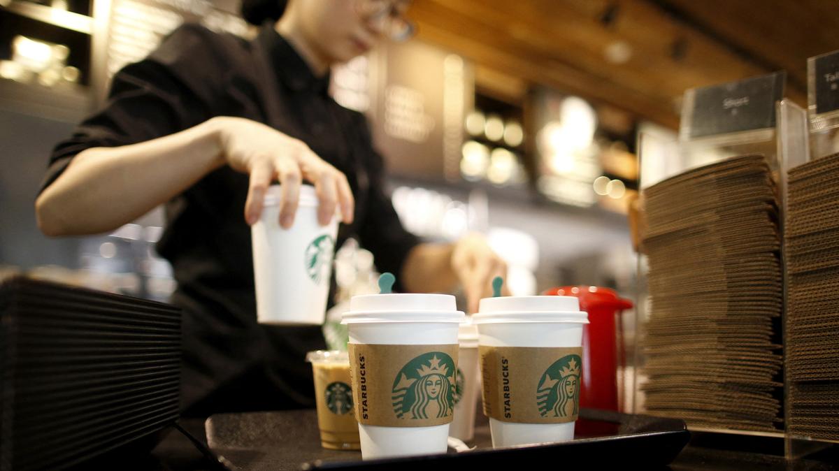 FILE PHOTO: A staff serves beverages at a Starbucks coffee shop in Seoul, South Korea, March 7, 2016. Picture taken March 7, 2016. REUTERS/Kim Hong-Ji/File Photo