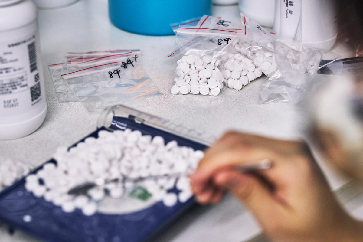 Wang Ming-yua bags medicine at her pharmacy in Taipei, Taiwan on April 9, 2026. Plastic producers in Taiwan have scrambled to secure new supplies since the war in Iran disrupted petrochemical flows and tightened availability. (An Rong Xu/The New York Times)