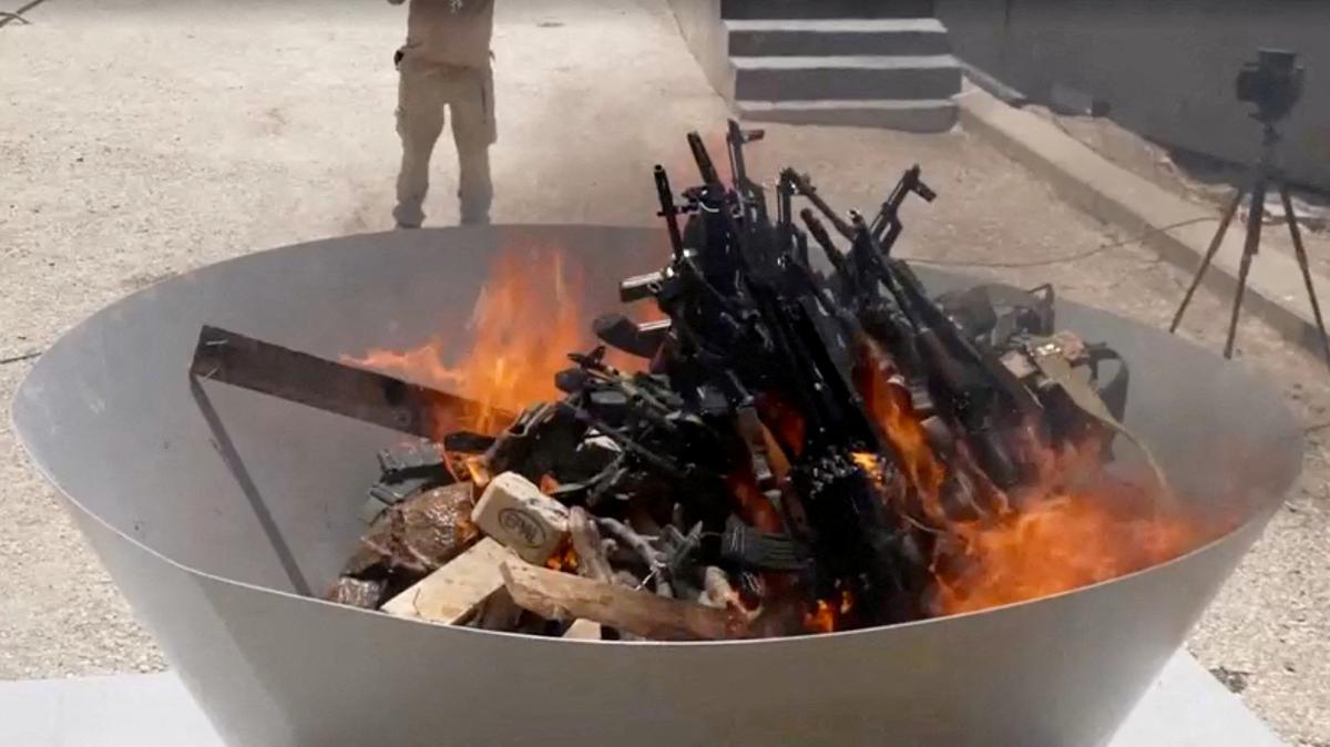 FILE PHOTO: Weapons placed by PKK fighters are burnt during a disarming ceremony in Sulaimaniya, Iraq, July 11, 2025, in this screengrab obtained from a handout video. KURDISTAN WORKERS PARTY MEDIA OFFICE/Handout via REUTERS/File Photo