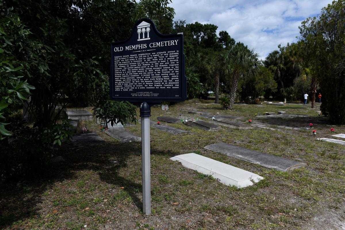A sign stands at The Old Memphis Cemetery, a predominantly African-American cemetery, after it was vandalized, with 17 gravesites and several headstones damaged in Palmetto, Florida, U.S., May 14, 2026. Authorities say “Trump” and “DeSantis” were spray-painted in red across several tombs as police continue investigating the incident. REUTERS/Octavio Jones