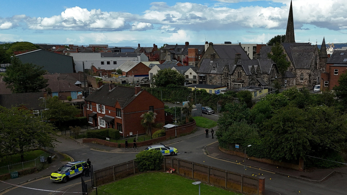 A drone view of police vehicles near a cordon at the scene of a stabbing outside apartments in the Kinnaird Avenue area of north Belfast, after a knife attack on June 8 left a man seriously injured and prompted police to declare a critical incident, in Belfast, Northern Ireland, June 9, 2026. REUTERS/Isabel Infantes