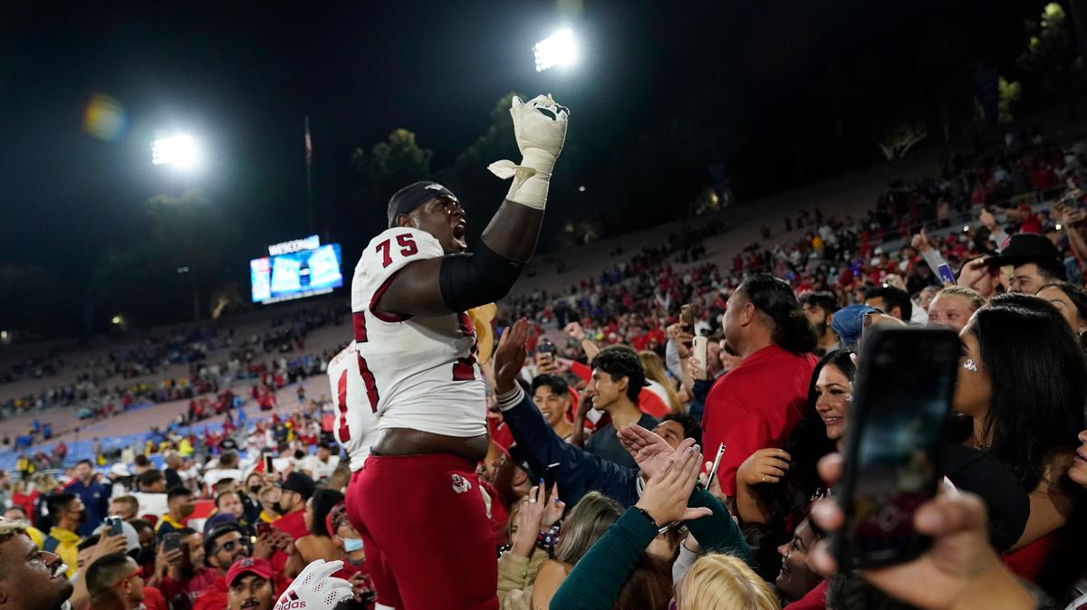 Fresno State offensive lineman Alex Akingbulu celebrates with the Red Wave after the win over UCLA in the Rose Bowl in September.