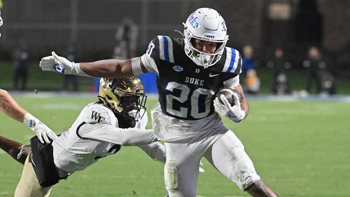  Nov 29, 2025; Durham, North Carolina, USA; Duke Blue Devils running back Nate Sheppard (20) runs the ball against Wake Forest Demon Deacons defensive back Karon Prunty (3) during the fourth quarter at Wallace Wade Stadium. Mandatory Credit: Zachary Taft-Imagn Images | Zachary Taft-Imagn Images 
