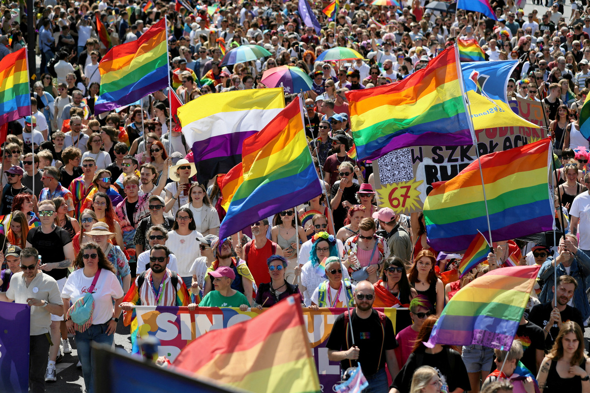 FILE PHOTO: Participants march, some carrying rainbow flags, at the LGBT+ pride parade, known as the "Equality March" under the theme, "The Answer is Love", in Warsaw, Poland June 14, 2025. Agencja Wyborcza.pl/Slawomir Kaminski via REUTERS/File Photo