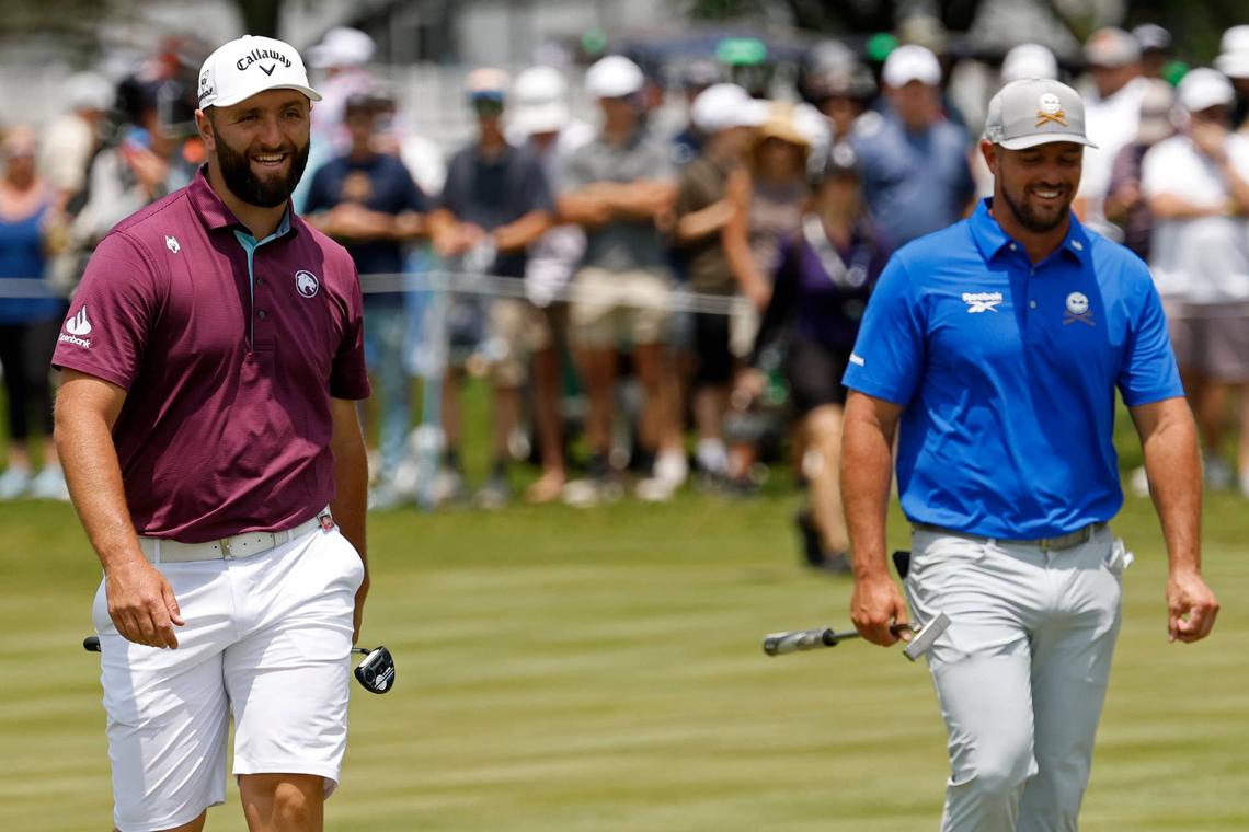  Jun 6, 2025; Gainesville, Virginia, USA; Jon Rahm of team Legion XIII (L) jokes with Bryson DeChambeau of team Crushers GC (R) while walking to the green on the third hole during the first round of the LIV Golf Virginia golf tournament at Robert Trent Jones Golf Club. Mandatory Credit: Geoff Burke-Imagn Images 