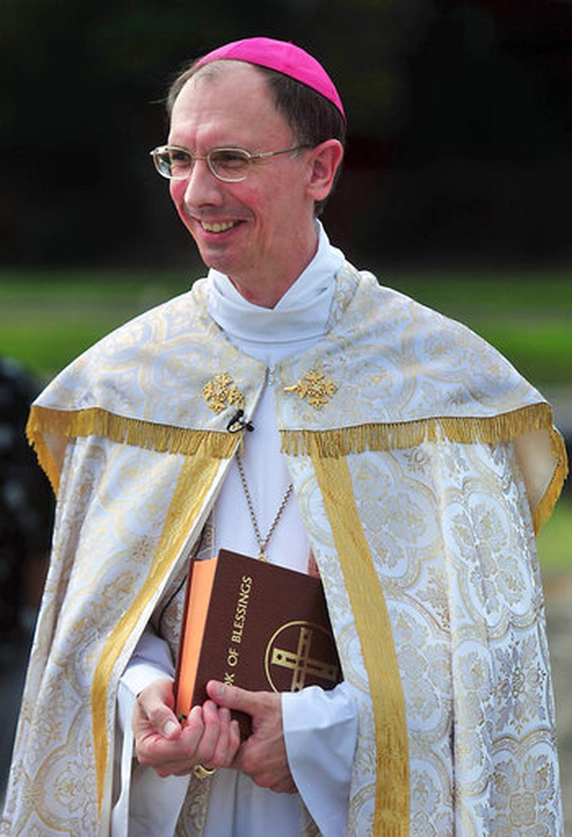 This July 9, 2014, photo shows Bishop Peter Jugis at a groundbreaking ceremony for Mother Teresa Villa apartment homes for low-income disabled adults in Charlotte, N.C. canceled most Masses late Saturday after Gov. Roy Cooper banned gatherings of 100 people or more.