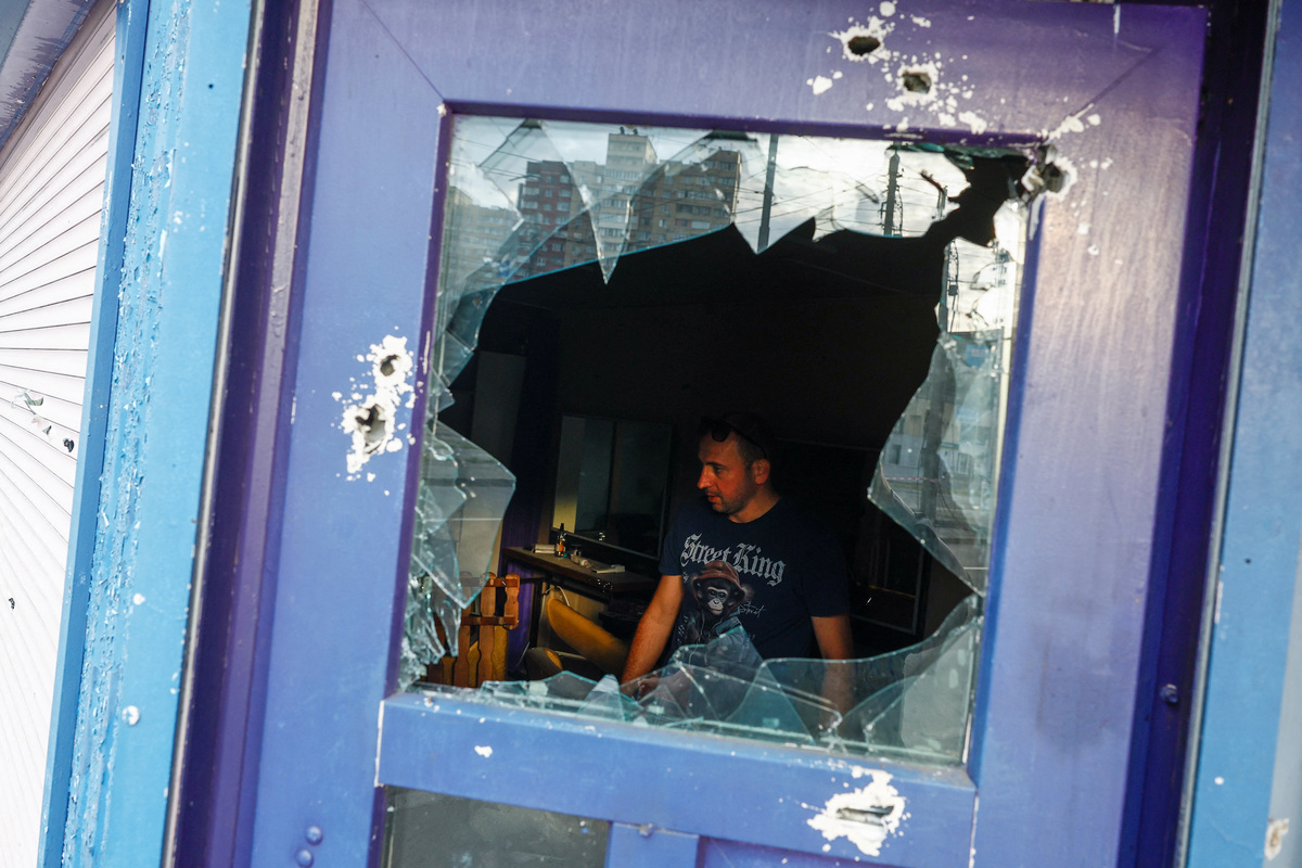 A resident removes debris inside his barbershop, which was damaged during Russian missile strikes, amid Russia's attack on Ukraine, in Kyiv, Ukraine July 11, 2026. REUTERS/Valentyn Ogirenko