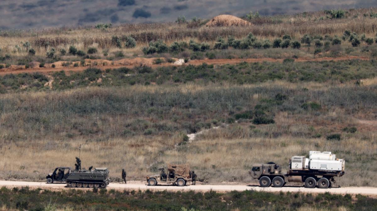 Israeli soldiers near military vehicles in Lebanon, as seen from the Israeli side of the Israeli-Lebanese border, June 1, 2026. REUTERS/Amir Cohen