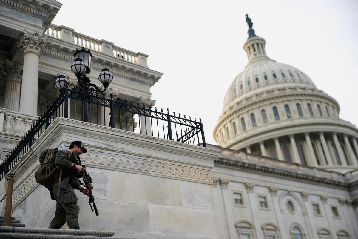 FILE PHOTO: A member of the U.S. Capitol police patrols following a vote in the U.S. House of Representatives on a bipartisan war powers resolution aiming to stop the military campaign against Iran, on Capitol Hill, in Washington, D.C., U.S., March 5, 2026. REUTERS/Nathan Howard/File Photo