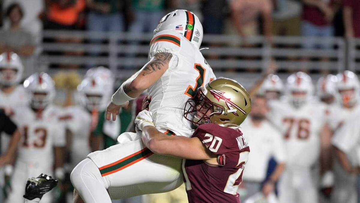  Oct 4, 2025; Tallahassee, Florida, USA; Miami Hurricanes quarterback Carson Beck (11) is tackled by Florida State Seminoles linebacker Blake Nichelson (20) during the first half at Doak S. Campbell Stadium. Mandatory Credit: Melina Myers-Imagn Images | IMAGN IMAGES via Reuters Connect 